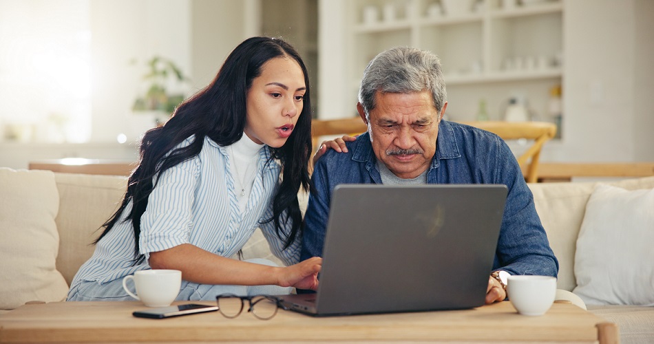 Woman, senior dad and laptop with teaching, reading and typing for email notification, web or search. Computer, elderly father and daughter with click, learning and family home lounge on social media