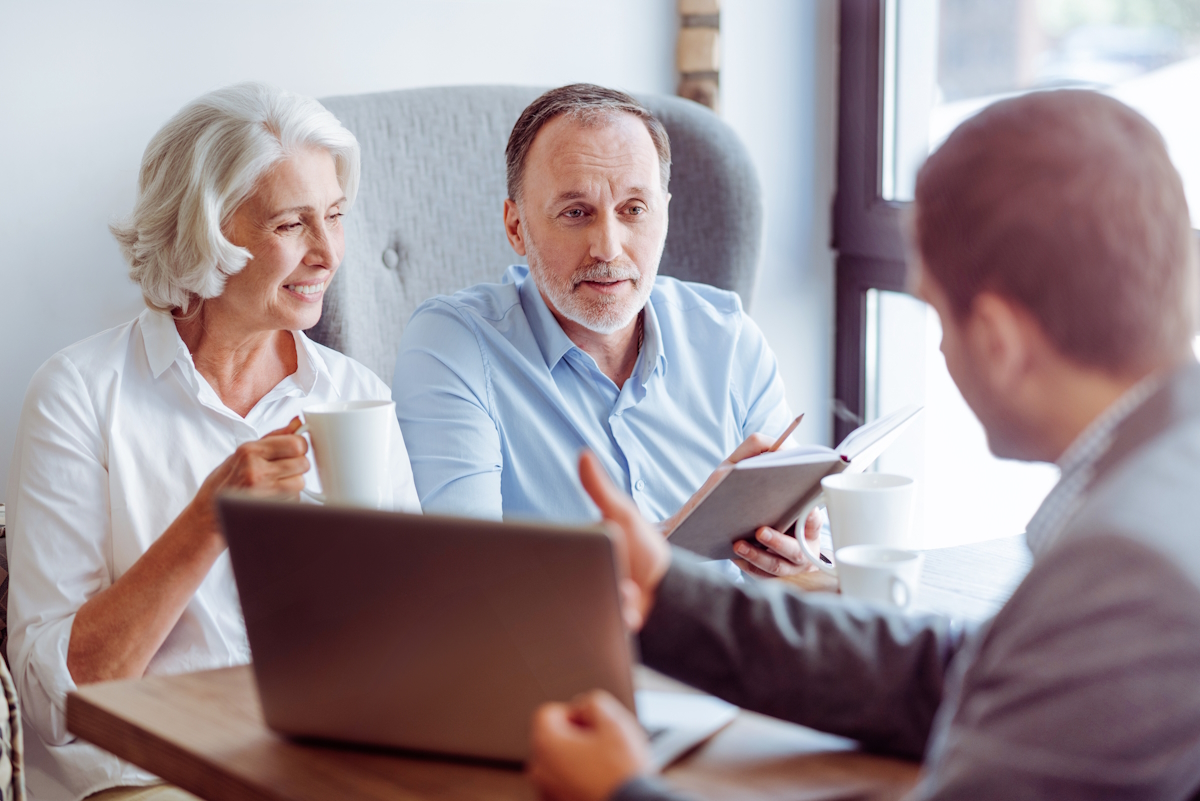 Medicare enrollment aged couple consulting with advisor