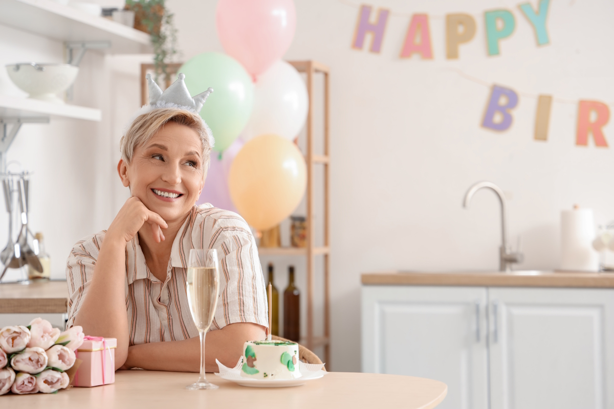 Medicare enrollment mature woman celebrating her birthday in kitchen