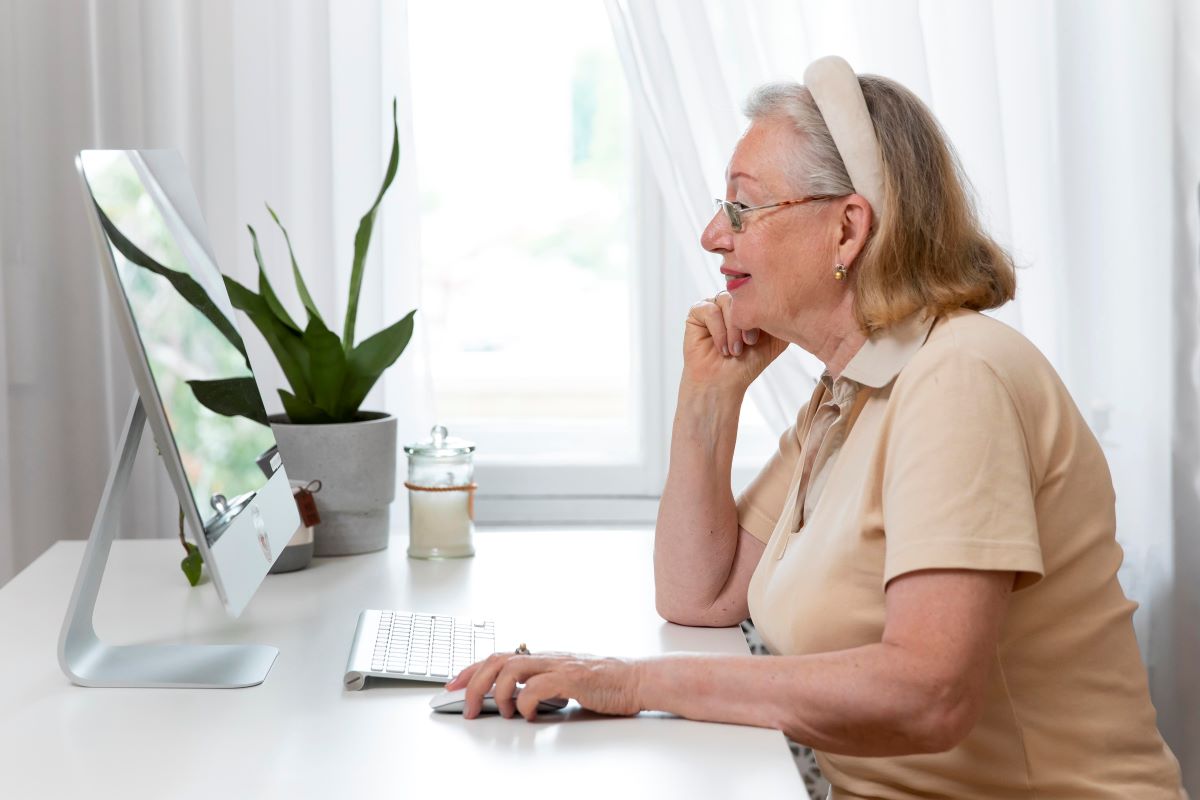 elder fraud senior woman on computer